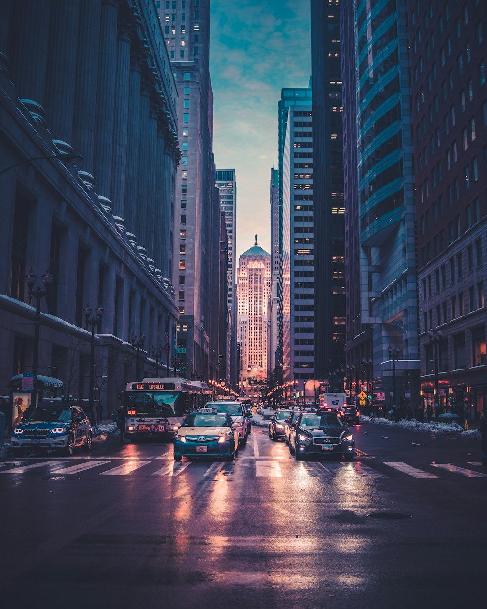 Chicago street framed by tall buildings in blue evening light